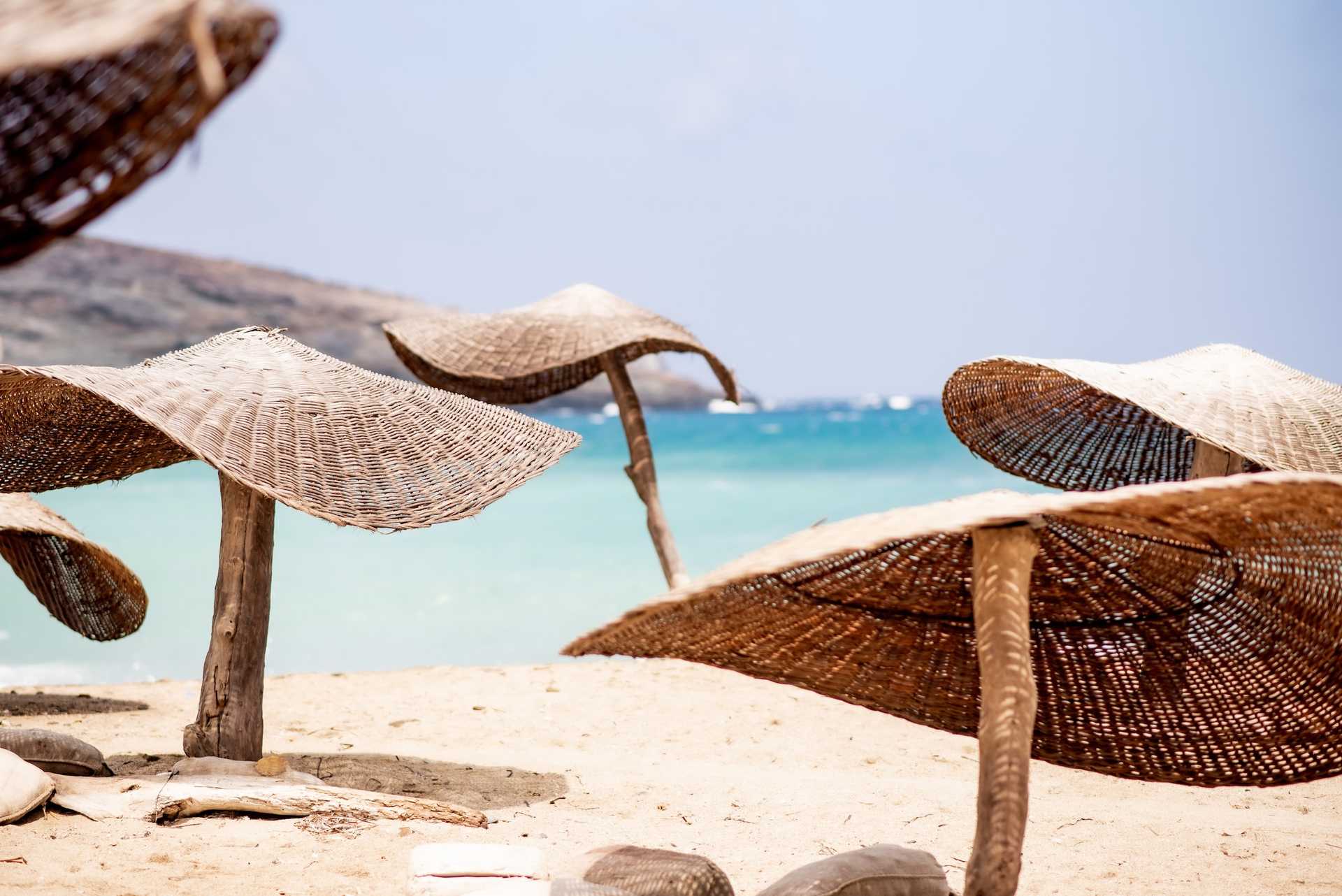 beach with straw umbrellas